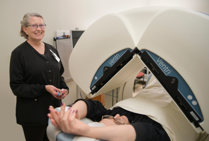 Medical professional assisting patient in MRI machine