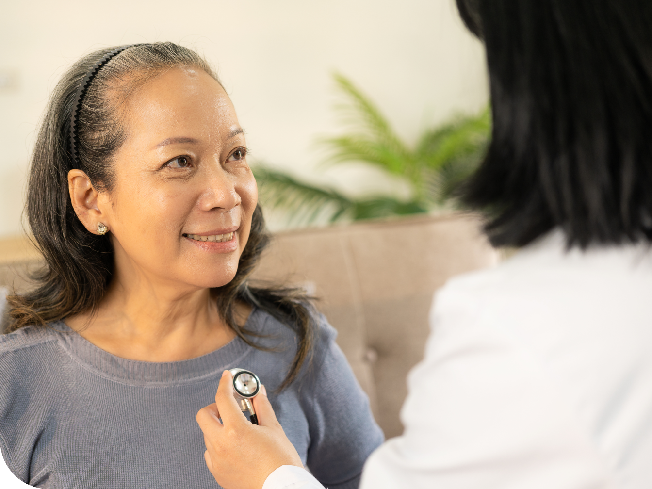 Doctor using a stethoscope on a patient