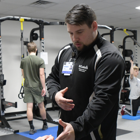 Sports performance coach in weight room