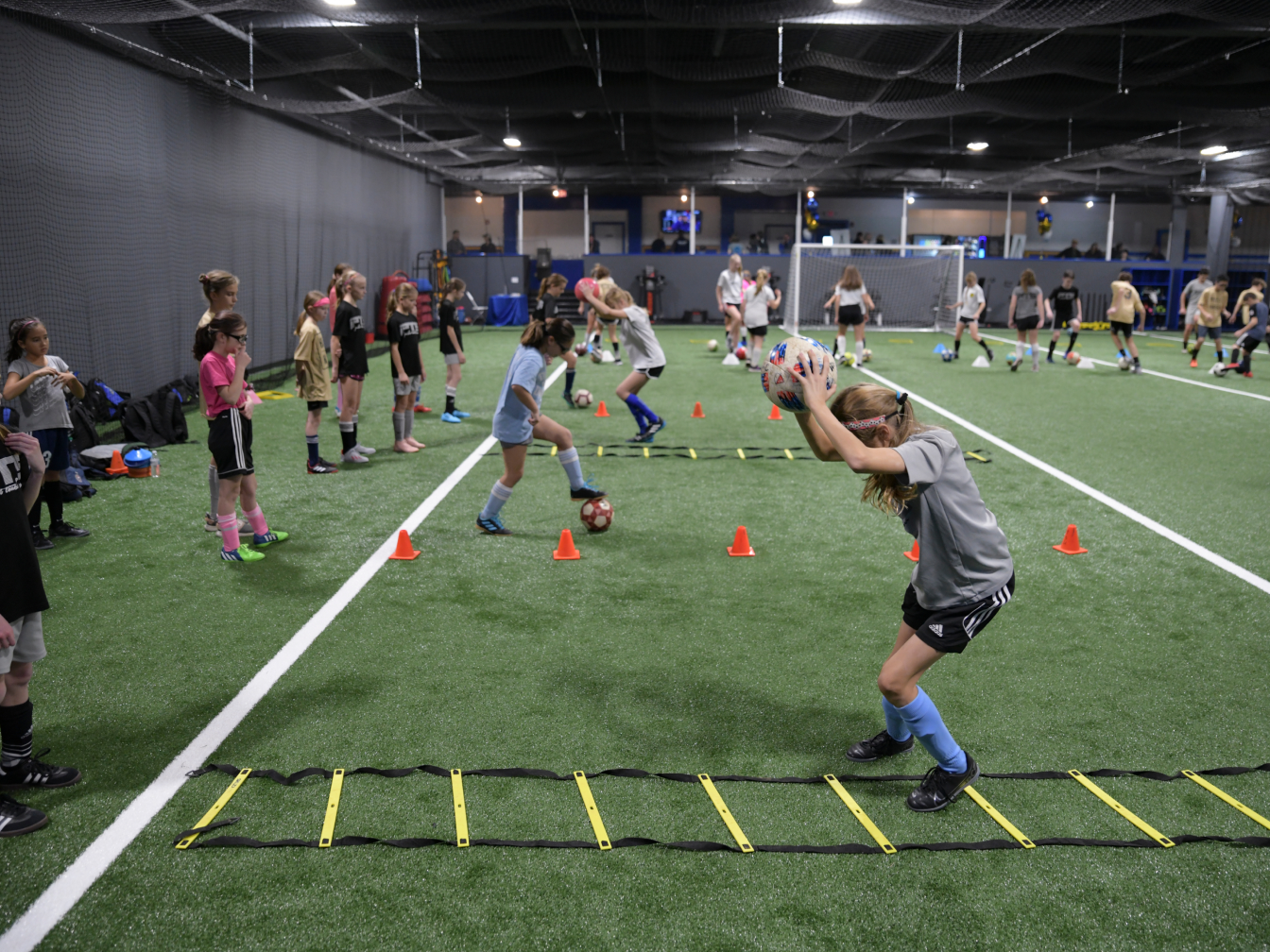 Young athletic team training on indoor field