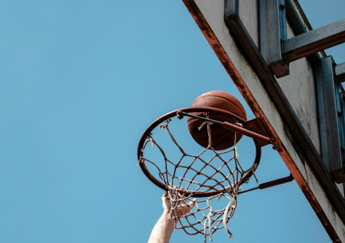 basketball going into an outdoor basketball net