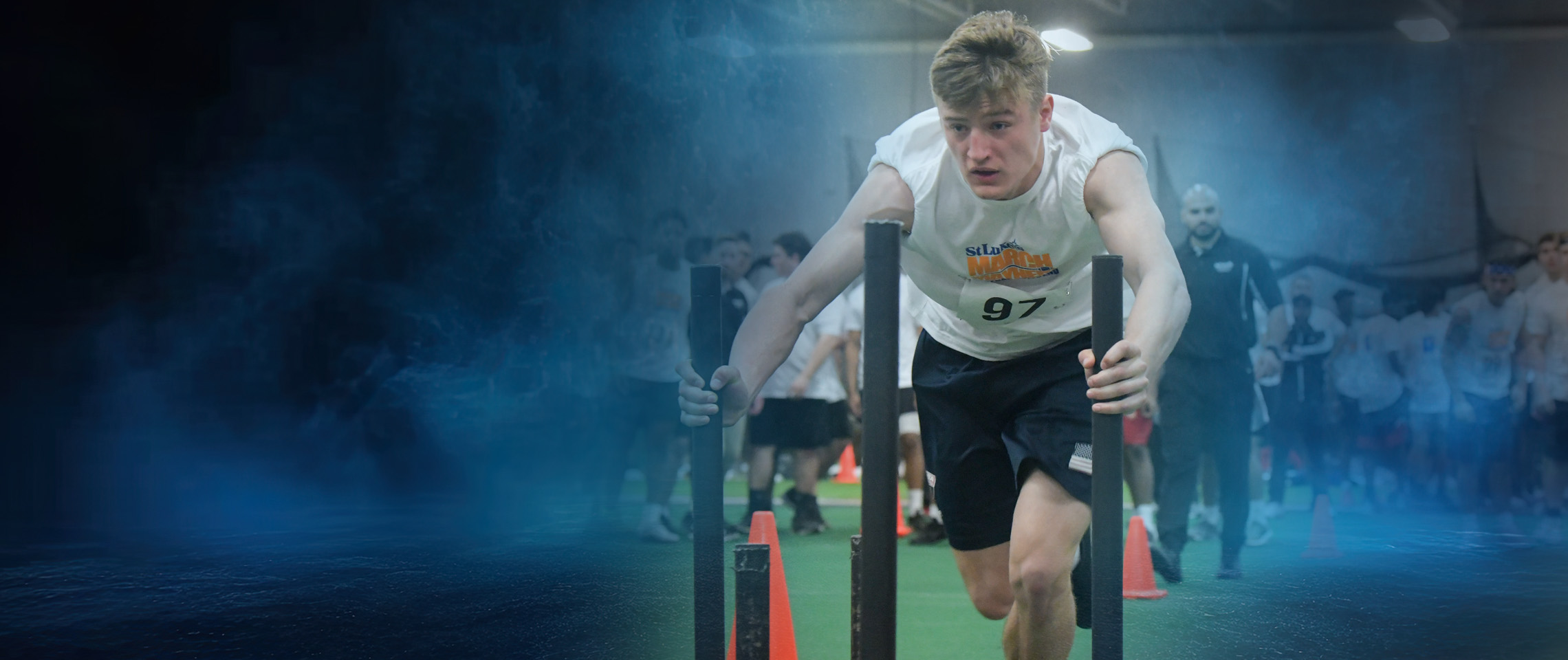 Young athlete pushing weighted sled