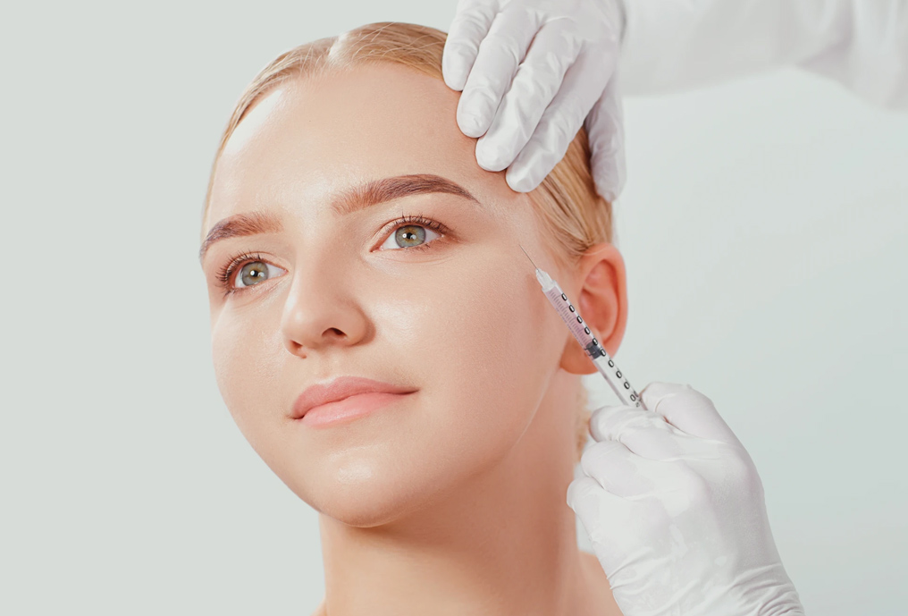 Young woman receiving a botox injection