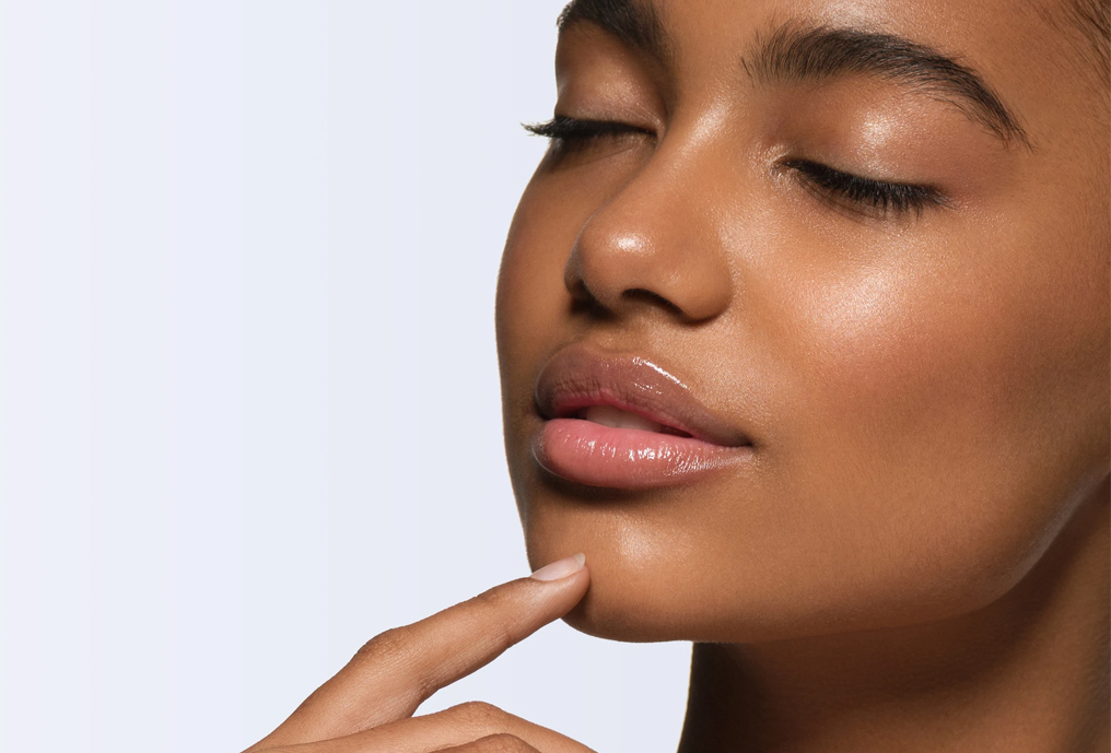 Young female with fingers on her chin