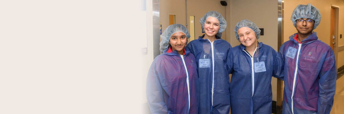 Group of four college students in hospital hallway