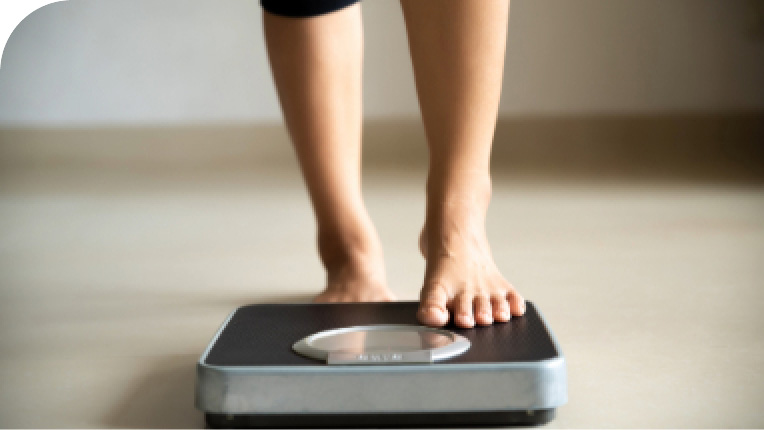 Individual stepping on a scale