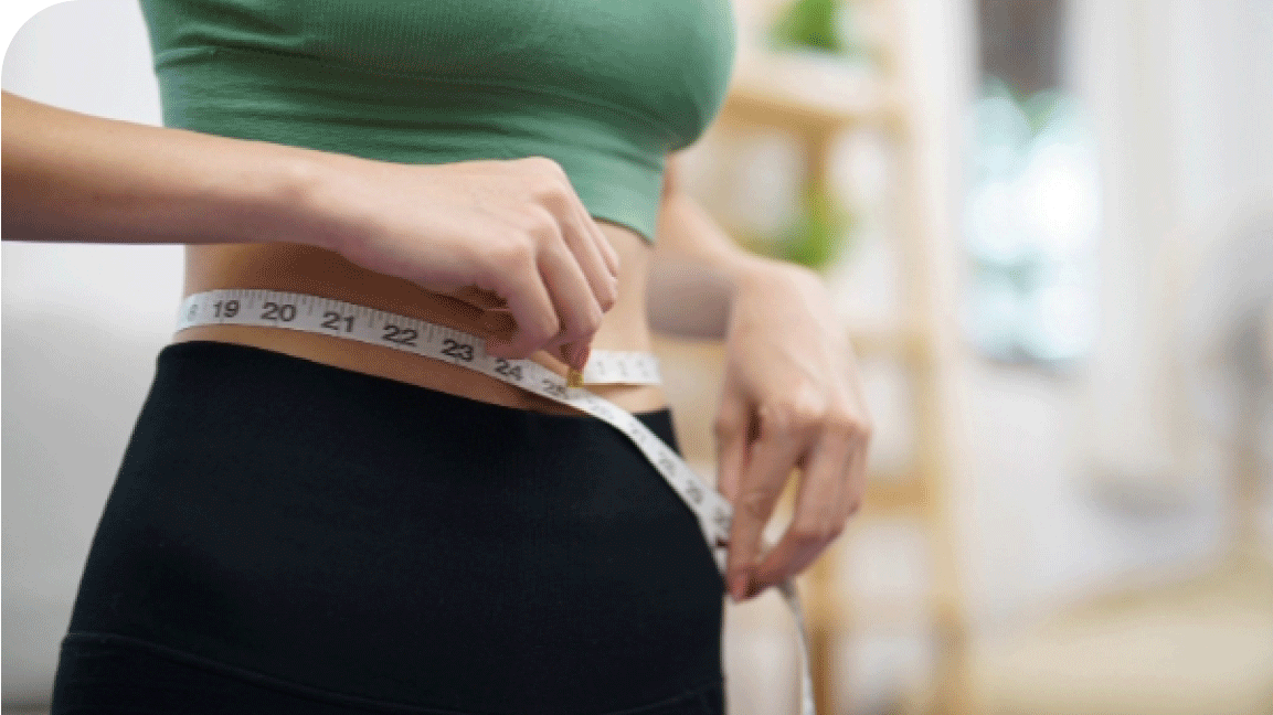 Woman measuring waistline