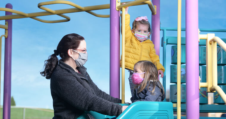 Mother playing on a playground with her children