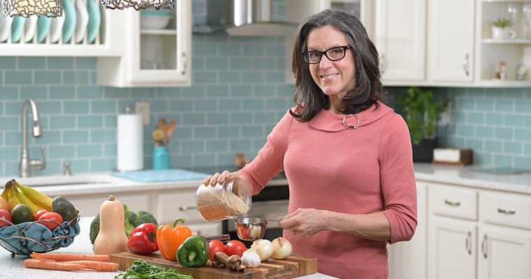 Woman in a kitchen cooking healthy food