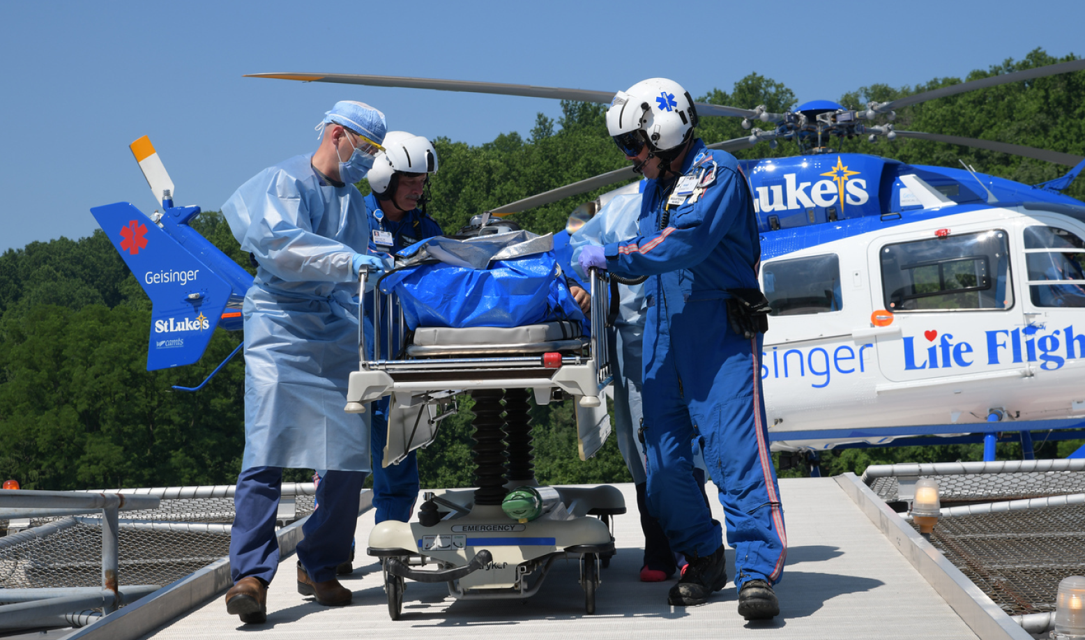 St. Luke's helicopter with medical team helping a patient